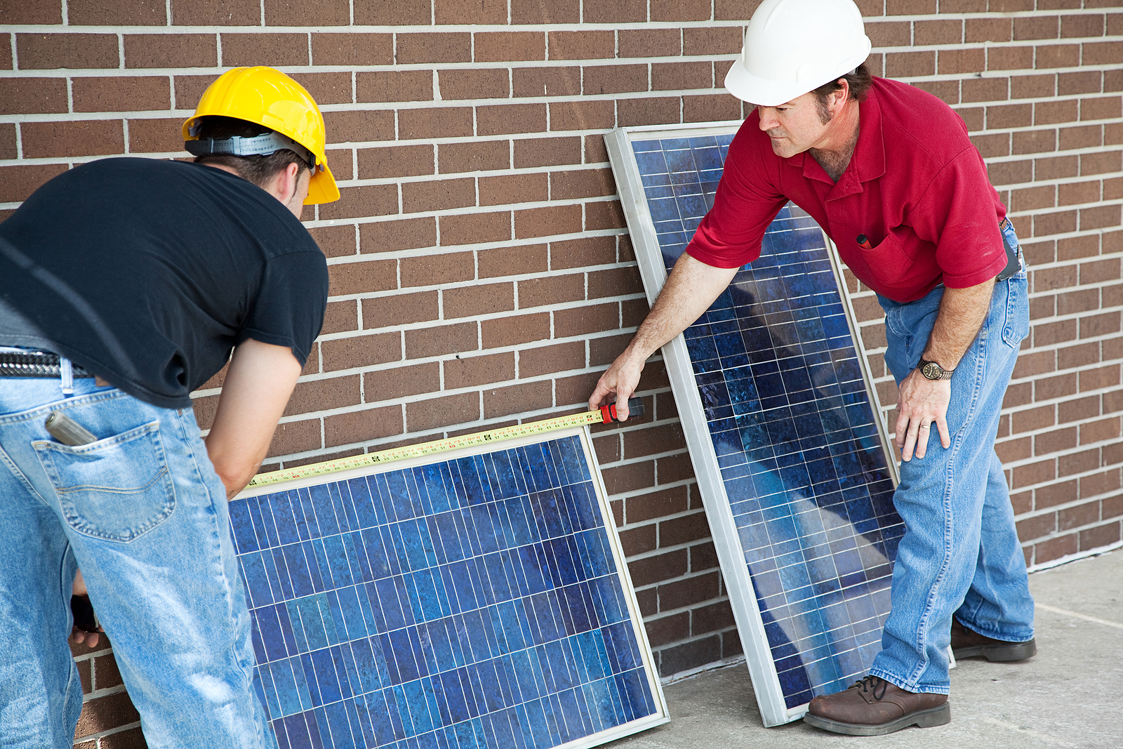 Electricians using solar panels for electricity