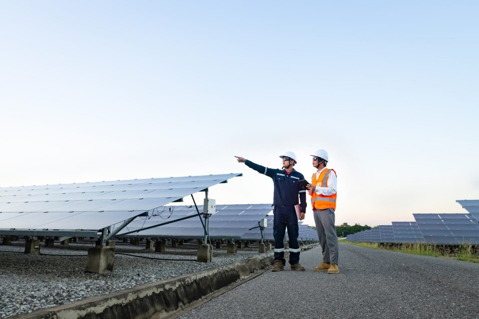 Engineers with investor walk to check the operation of the solar farm(solar panel) systems, Alternative energy to conserve the world is energy, Photovoltaic module idea for clean energy production.